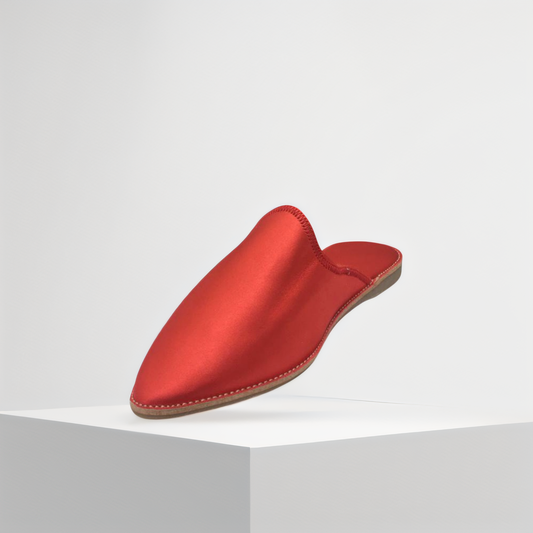 Authentic handcrafted Moroccan babouche in a bold red satin finish, featuring Berber cultural influences. A luxurious, high-quality slipper that embodies Moroccan craftsmanship and elegance.